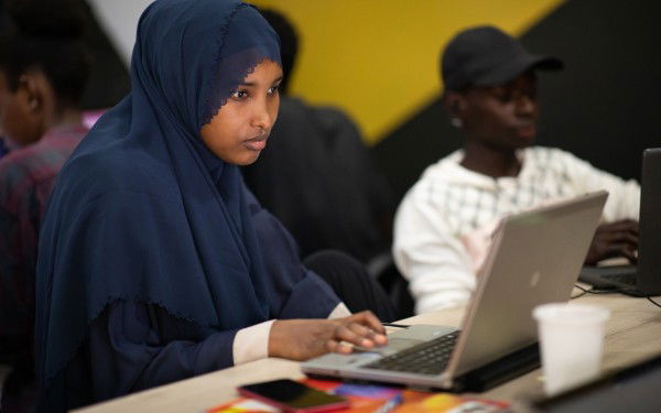 A woman is working on a laptop.